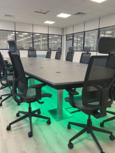 Completed boardroom table and chairs with green LED lights
