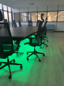 Completed boardroom table and chairs with green LED lights