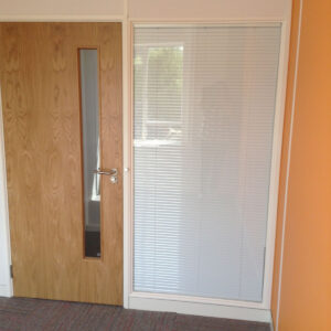 Office wall with glazed panel and door