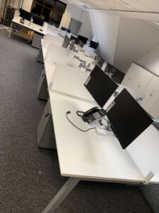 Office workstations with PC screens, divider screens and pedestals