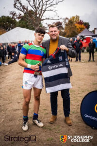 Pat at the rugby with players from winning team