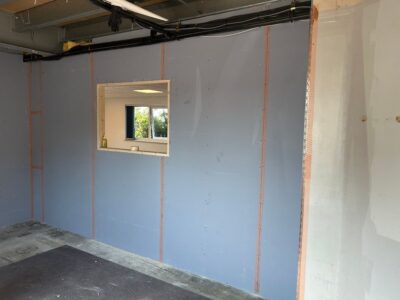Strip-out and rebuild phase showing stud walls and electrical cabling